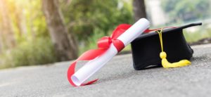 grad diploma on pavement